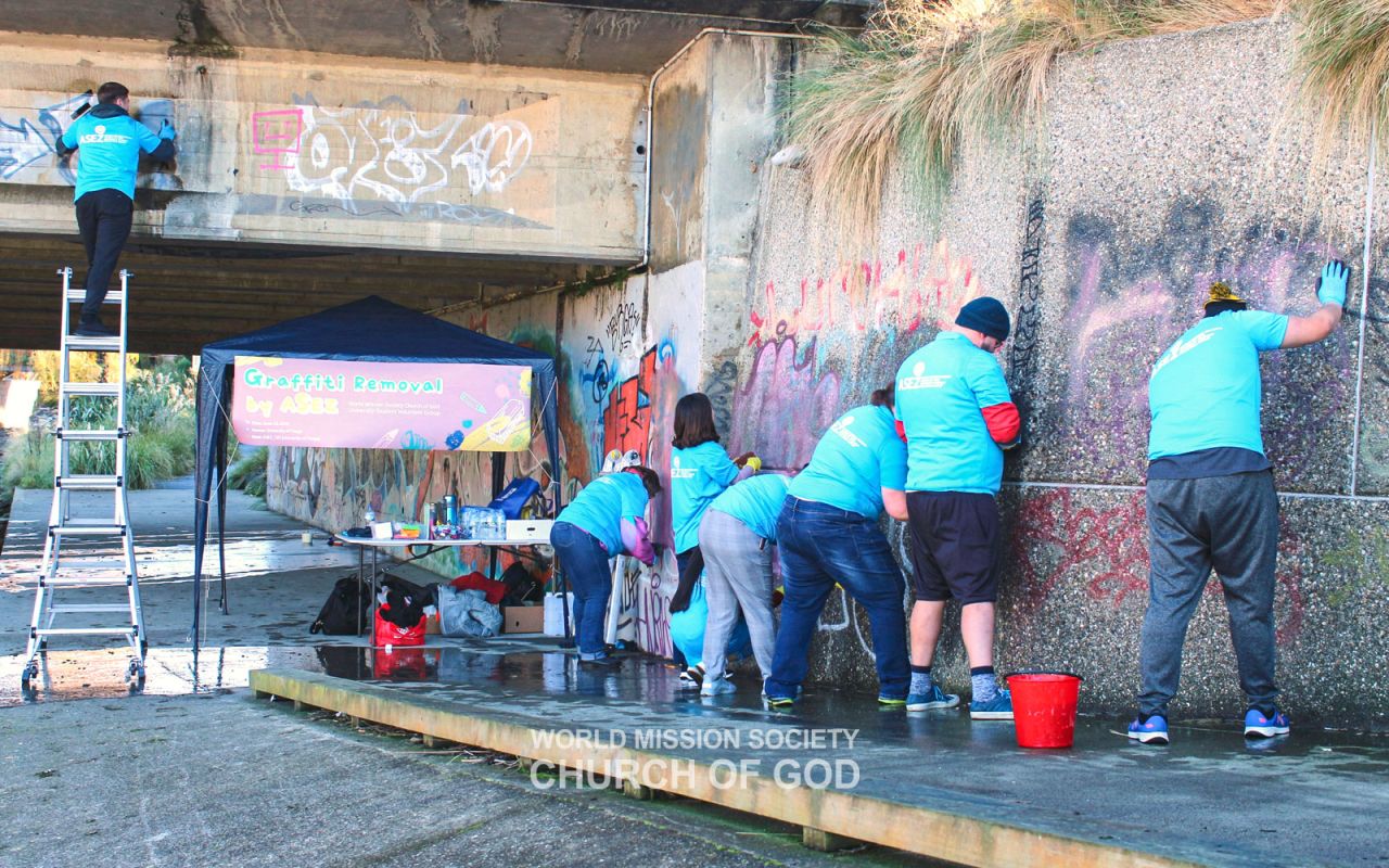 ASEZ members in Dunedin remove graffiti around the University of Otago