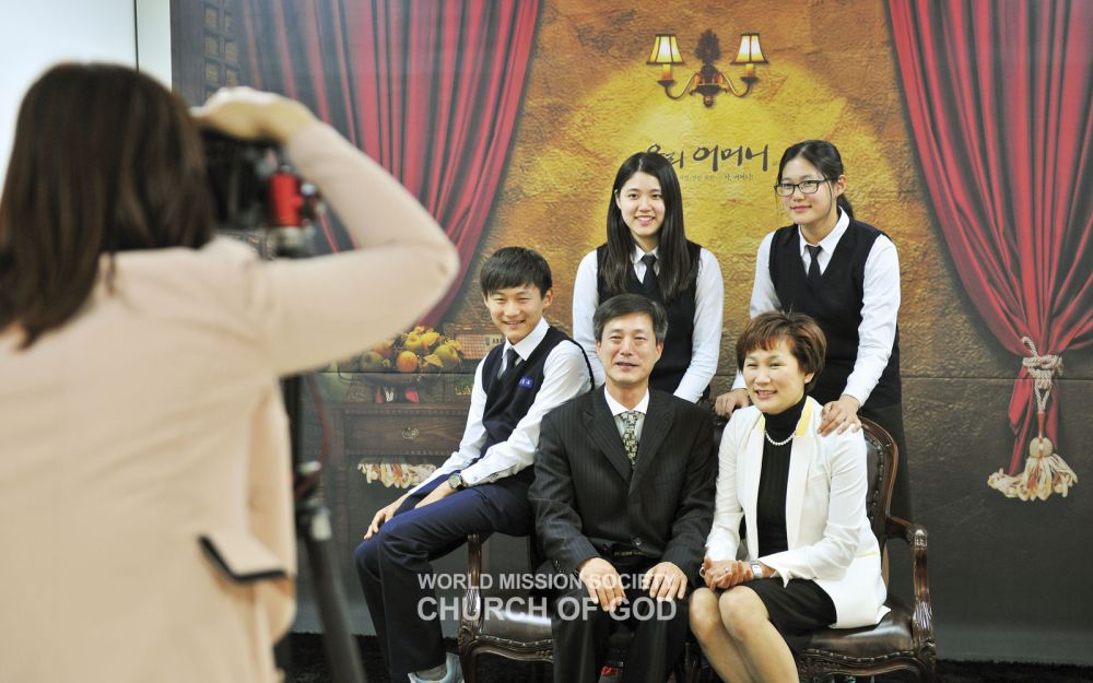 Visitors taking family photos at a 'photo zone'