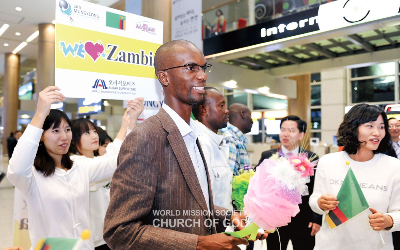 The Church of God Aura Supporters cheer for the Zambia national team at the Mungyeong Soft Tennis Championships.
